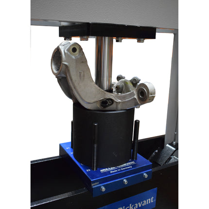 vehicle component being pressed with a hydraulic press, whlist being held in place by the press ring sat on a press block