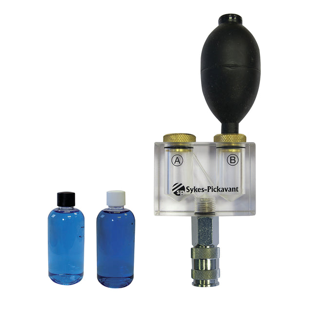 A Sykes-Pickavant combustion leakage tester with a clear body, black cap, and 2 bottles of reaction fluid.